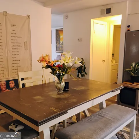 a room with pool table and potted plants