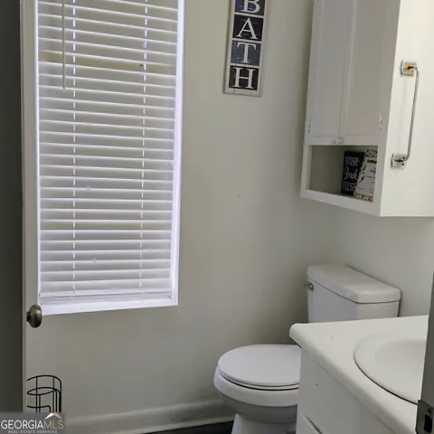 a white toilet sitting next to a bathroom sink