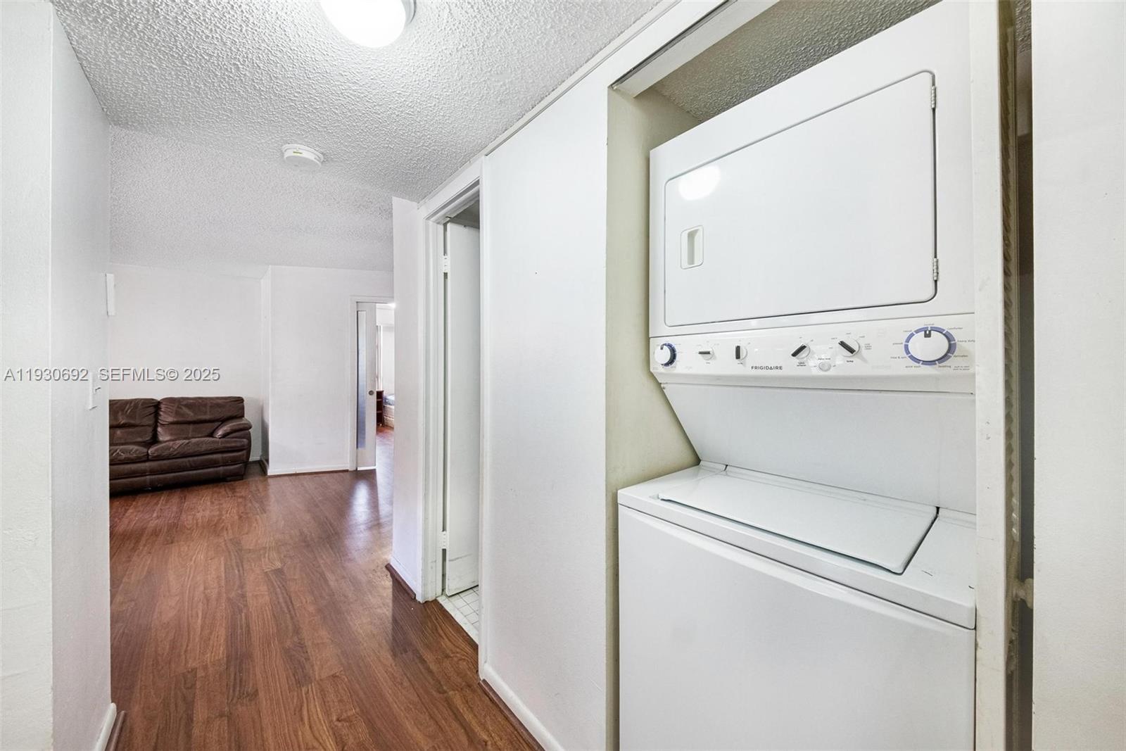 2000 Towerside Terrace, Unit 412 Miami, FL 33138 - Photo 11 of 57 a view of washer and dryer with wooden floor