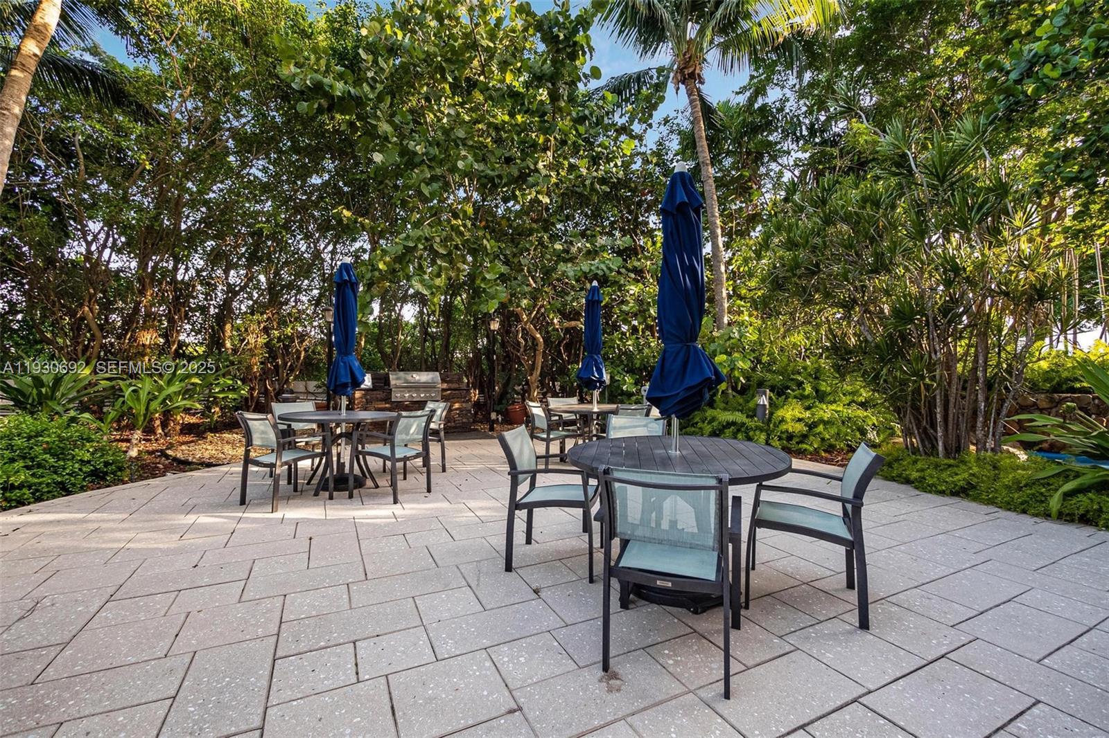 2000 Towerside Terrace, Unit 412 Miami, FL 33138 - Photo 34 of 57 a view of a tables and chairs in a patio