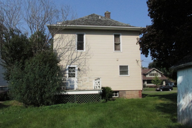 1017 South Church Street Princeton, IL 61356 - Photo 3 of 3 a white house sitting in middle of the grass