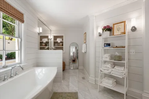 a spacious bathroom with a double vanity sink a mirror and shower