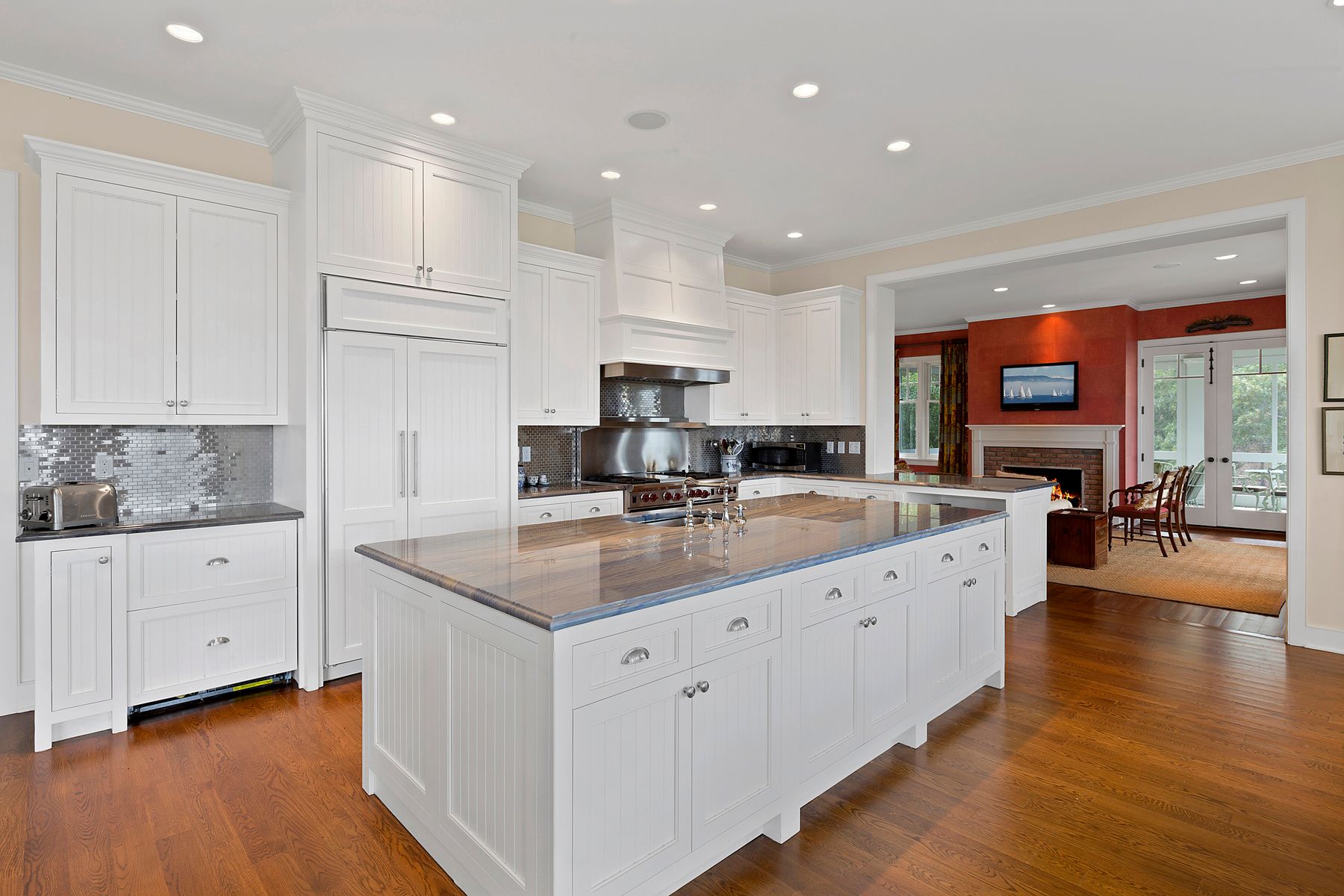 182 Springy Banks Road East Hampton, NY 11937 - Photo 5 of 12 a kitchen with stainless steel appliances granite countertop a sink a stove and a wooden floors