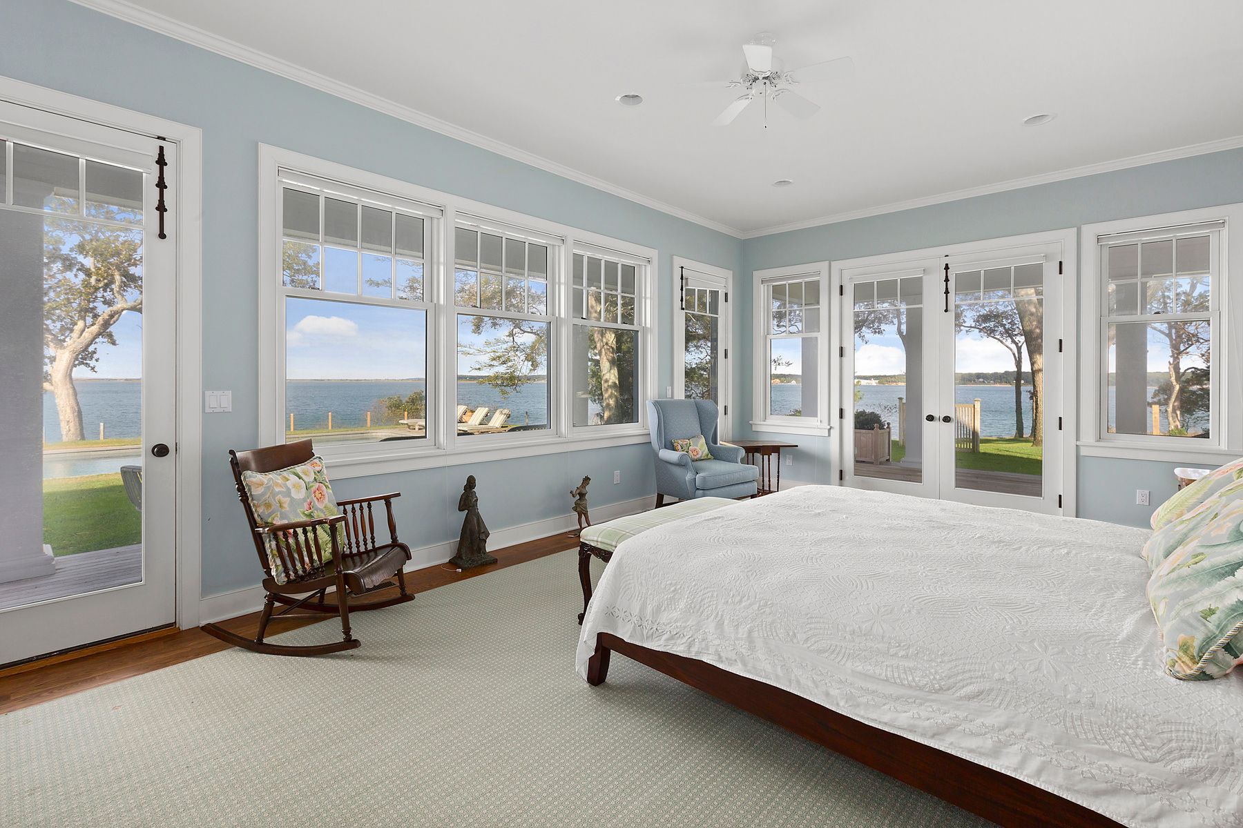 182 Springy Banks Road East Hampton, NY 11937 - Photo 7 of 12 a bedroom with a bed a table and large windows