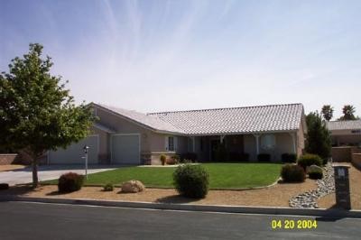 12931 Tawya Road Apple Valley, CA 92308 - Photo 1 of 1 a front view of a house with a yard