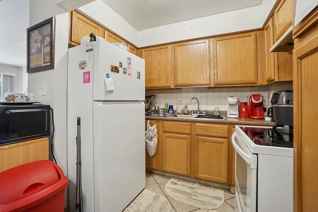 a white refrigerator freezer sitting in a kitchen