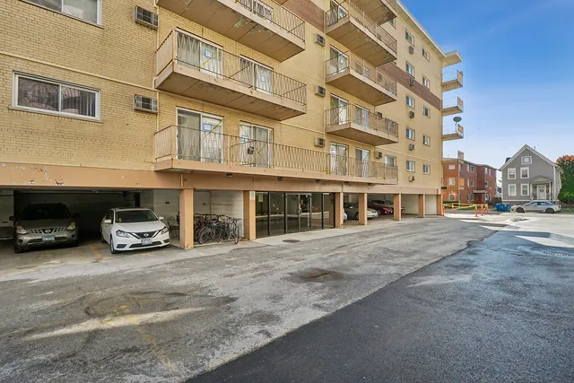 a view of a building with car parked