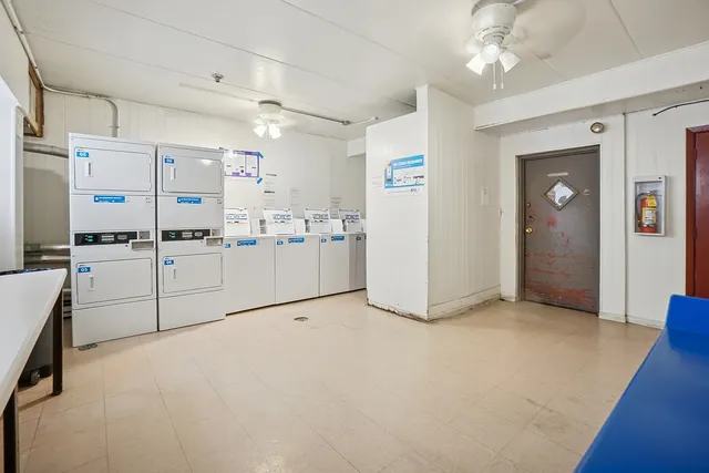 a view of a kitchen with refrigerator and windows