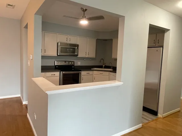 a kitchen with stainless steel appliances granite countertop a refrigerator and a sink