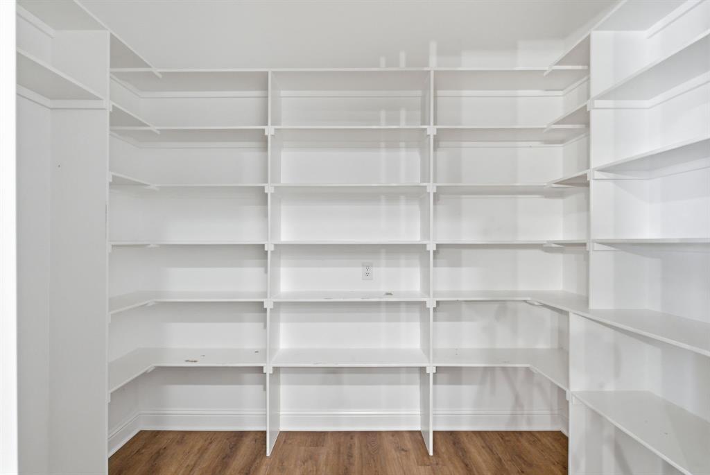 4600 Old Brock Road Weatherford, TX 76087 - Photo 14 of 37 Spacious walk-in pantry featuring extensive white shelving, wood-finish flooring, and ample storage capacity