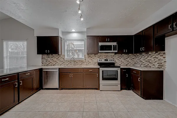 a kitchen with a stove microwave and cabinets