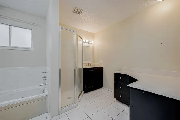 a bathroom with a bathtub sink and mirror
