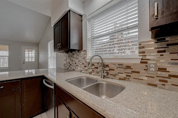 a kitchen with a sink and a microwave