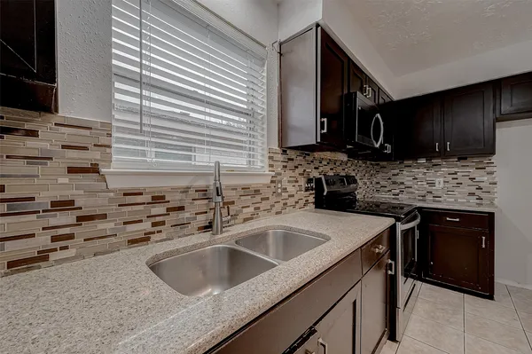 a kitchen that has a sink and a stove