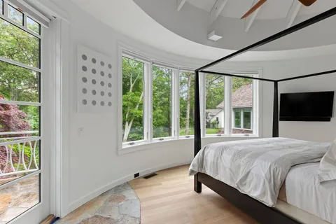a bedroom with a large bed and a large window