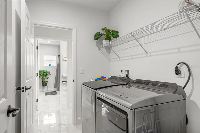 a view of a backyard with large trees and wooden fence