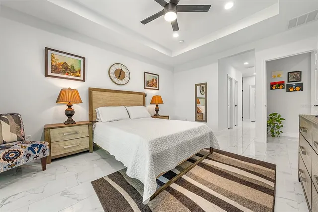 an aerial view of a house with swimming pool and large trees