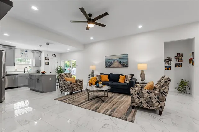 a living room with furniture potted plant and a chandelier