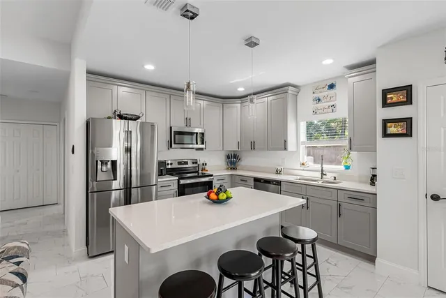 a bathroom with a granite countertop sink and a mirror with toilet