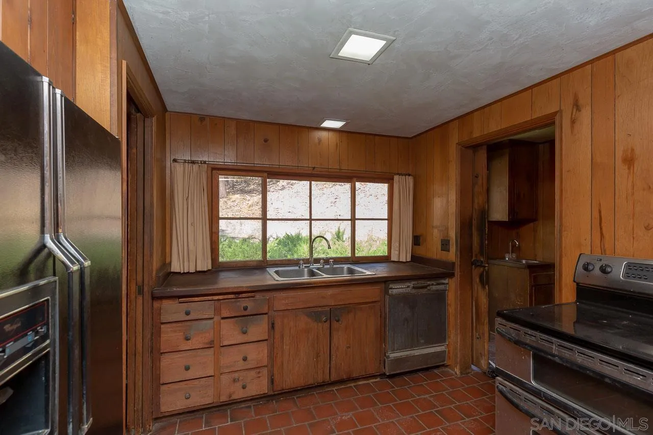 11855 Rocoso Road Lakeside, CA 92040 - Photo 3 of 16 a kitchen with a sink and large window