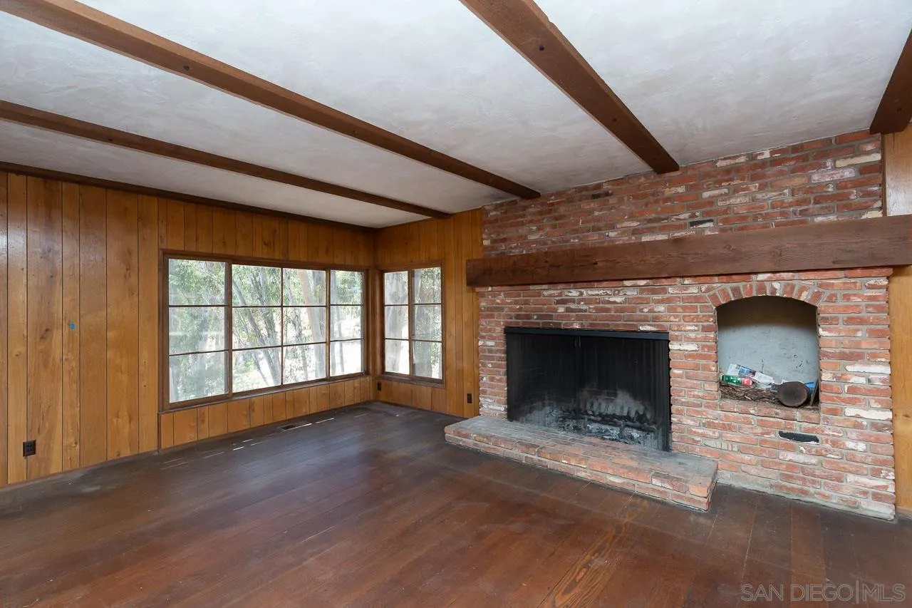 11855 Rocoso Road Lakeside, CA 92040 - Photo 5 of 16 a living room with a fireplace and wooden floor
