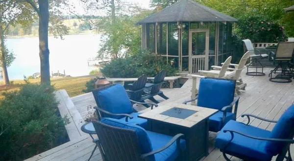 a view of balcony with wooden floor and outdoor seating
