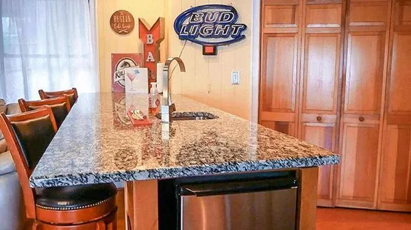 a kitchen with stainless steel appliances granite countertop a refrigerator a stove and a sink with cabinets