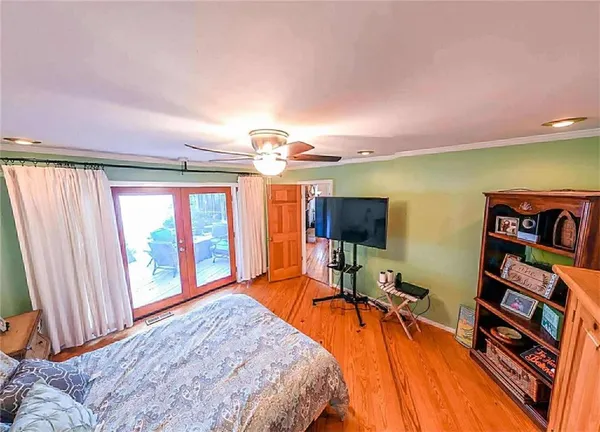 a bedroom with a bed and a large window
