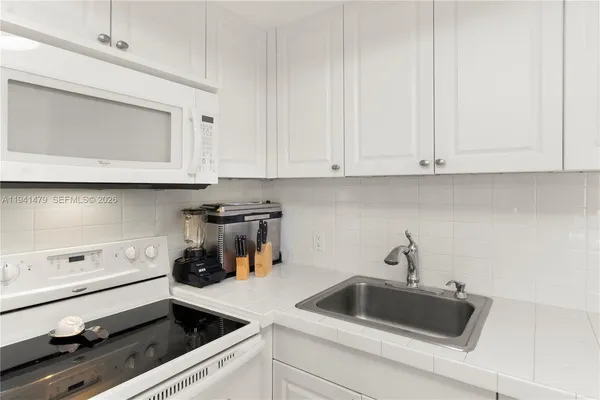 a kitchen with a sink and cabinets