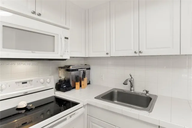 a kitchen with a sink and cabinets