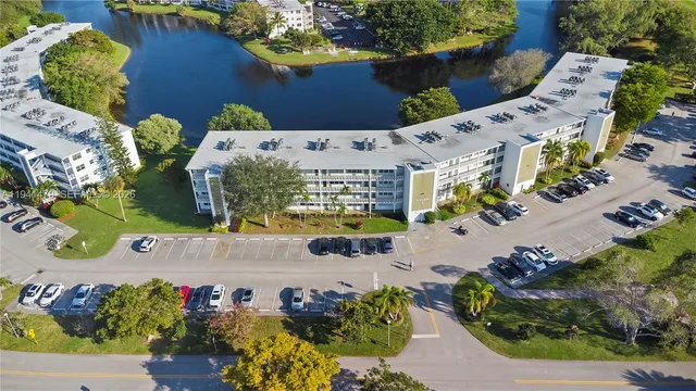 an aerial view of a house a garden and mountain view in back