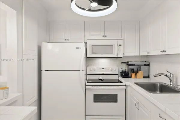 a kitchen with a sink a stove and refrigerator