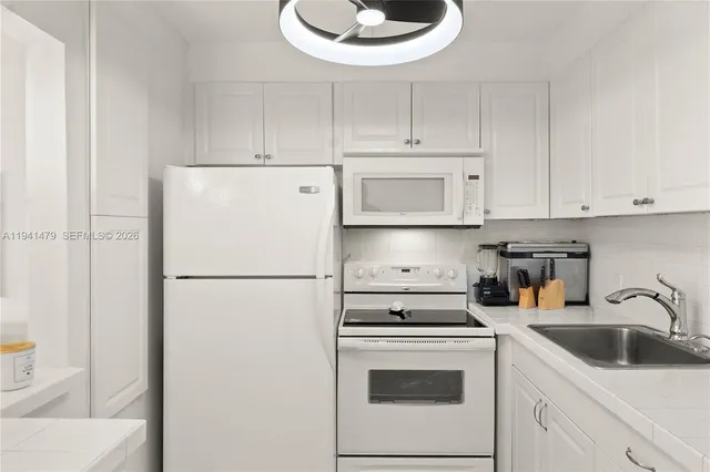 a kitchen with a sink a stove and refrigerator
