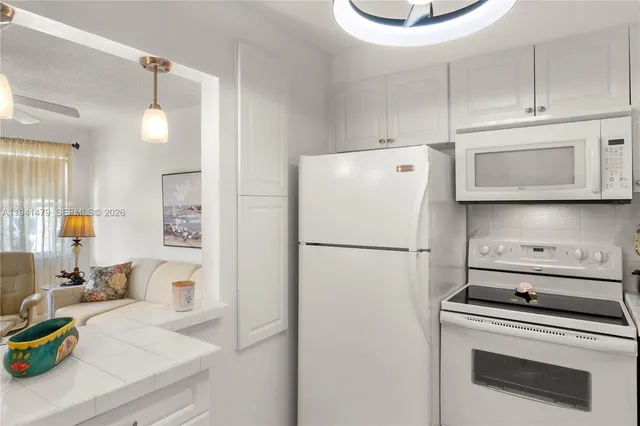 a white refrigerator freezer sitting inside of a kitchen