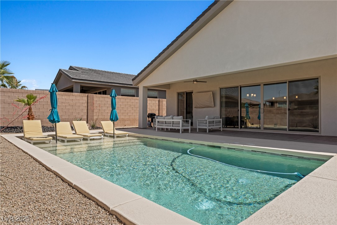 1357 Manassas Ridge Mesquite, NV 89027 - Photo 56 of 72 View of swimming pool featuring a patio area, an outdoor living space, and a ceiling fan