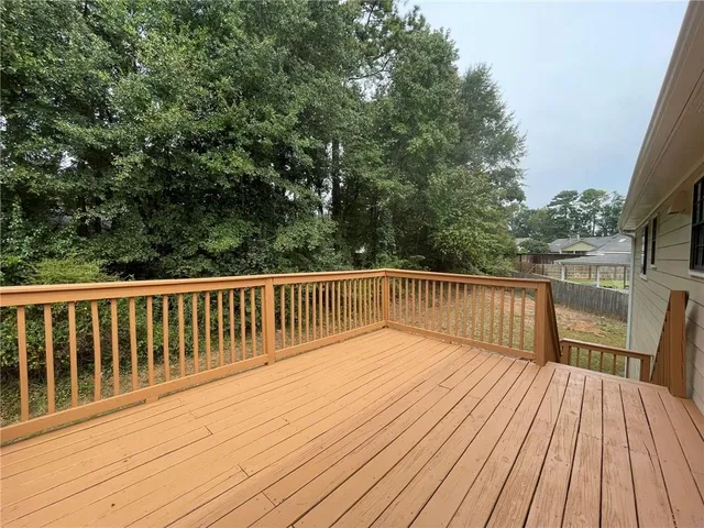 a balcony with wooden floor and fence