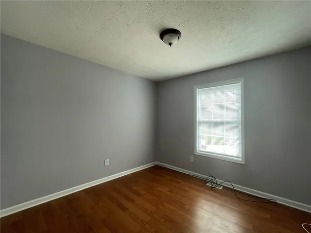 an empty room with a empty space and a window