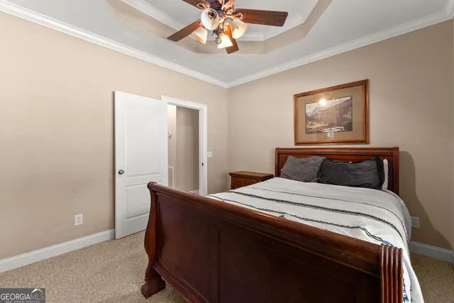 a view of a deck with large trees and wooden fence