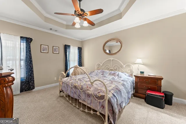 a front view of a house with a garden and yard