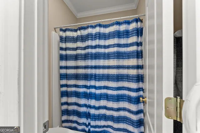 a view of a chair and table in backyard of the house