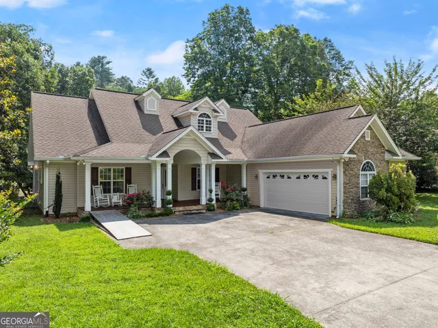 a view of a dining room with furniture wooden floor and chandelier
