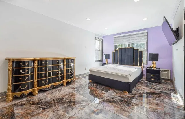 a bedroom with a bed and a flat screen tv