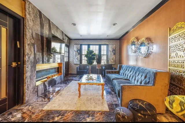 a living room with furniture and a painting on the wall