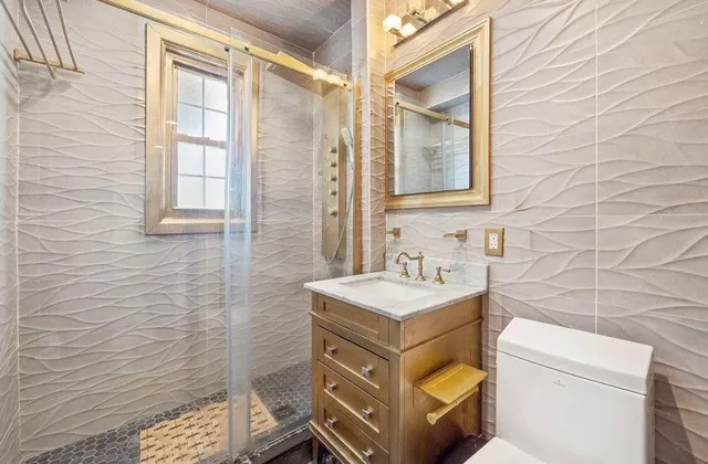 a bed sitting in a spacious bedroom next to a window