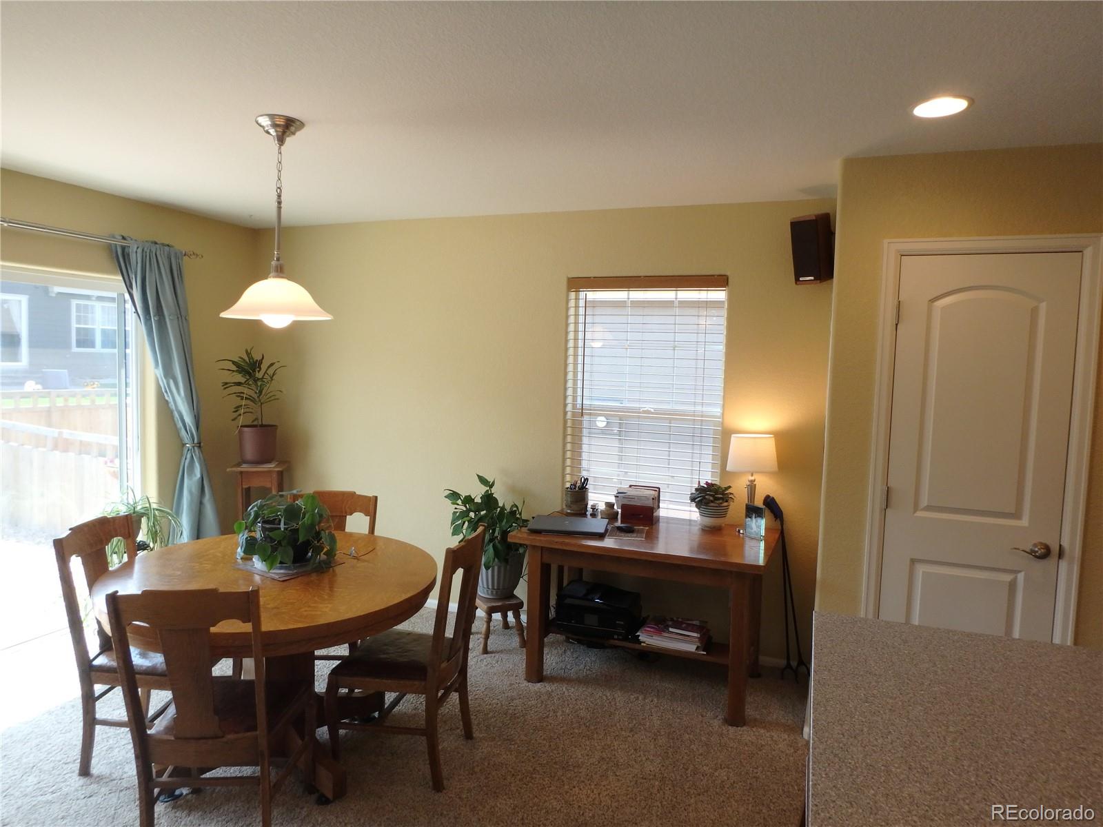 3268 Raintree Lane Dacono, CO 80514 - Photo 13 of 35 a dining room with furniture and window