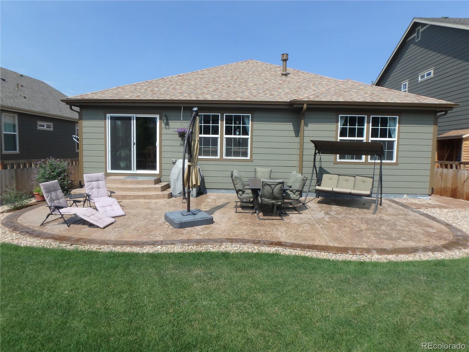 3268 Raintree Lane Dacono, CO 80514 - Photo 29 of 35 a front view of a house with patio and yard