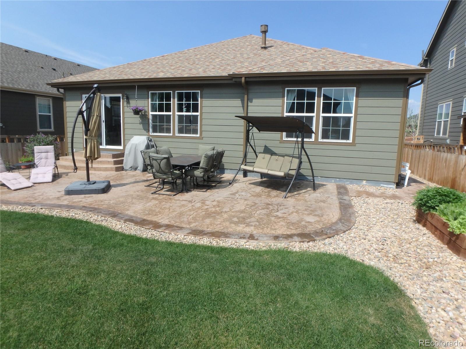 3268 Raintree Lane Dacono, CO 80514 - Photo 30 of 35 a backyard of a house with seating space