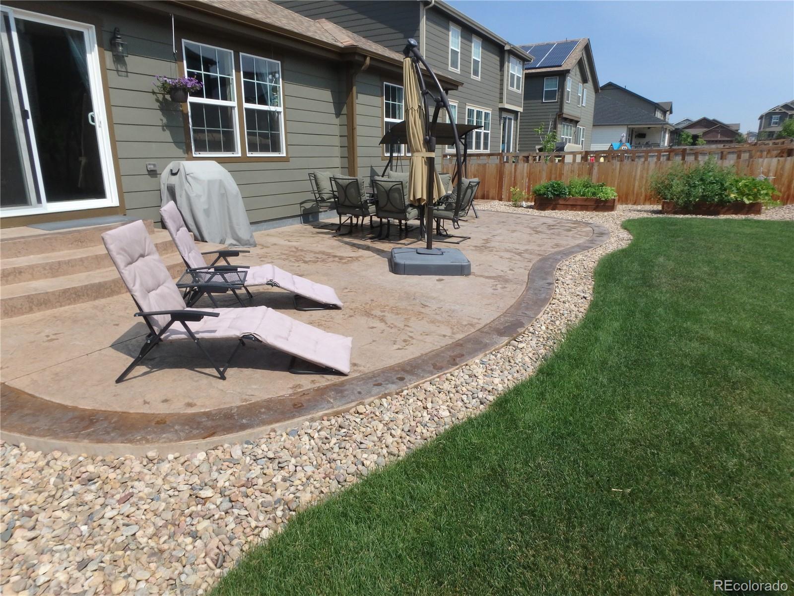 3268 Raintree Lane Dacono, CO 80514 - Photo 31 of 35 a view of a house with backyard