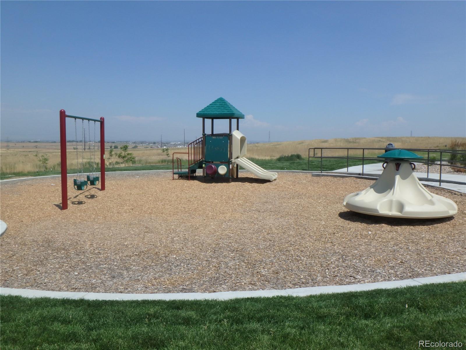 3268 Raintree Lane Dacono, CO 80514 - Photo 35 of 35 a table and chairs sitting in the middle of a field
