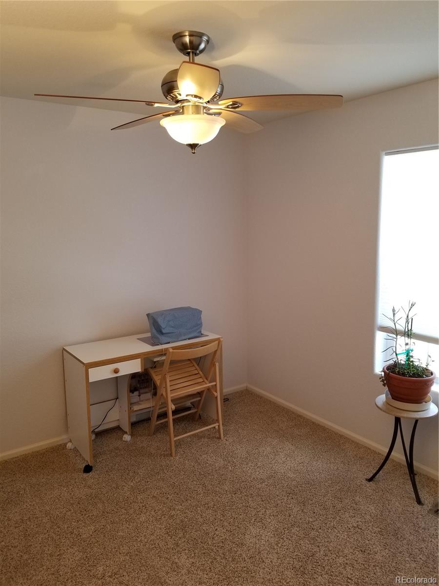 3268 Raintree Lane Dacono, CO 80514 - Photo 5 of 35 a view of a room with a hanging light and a window